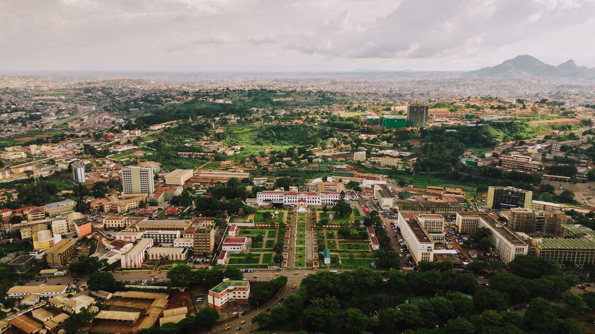 Yaoundé from the air, the government quarter and its formal gardens in the foreground and the city spreading over wooded hills to a rocky ridge on the horizon