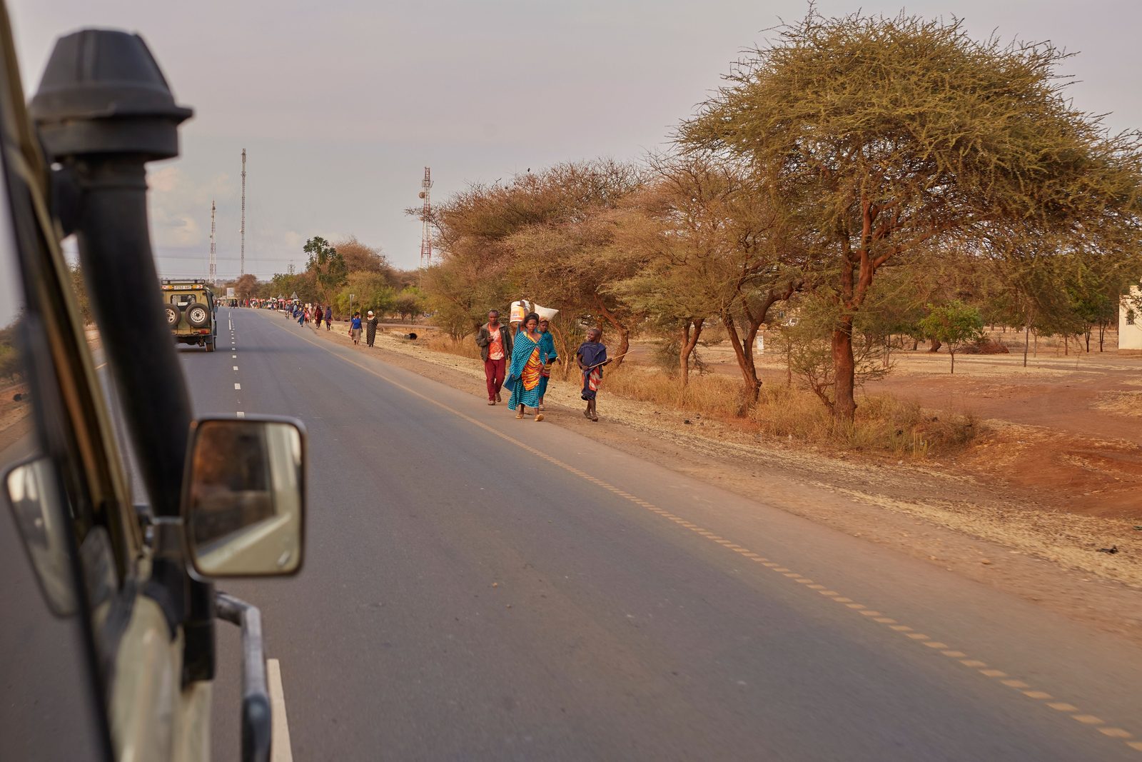 One vehicle on a dirt road, running into open country